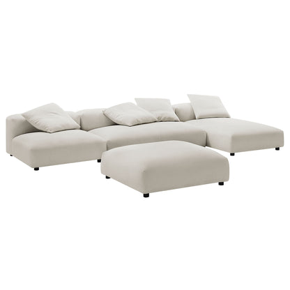 Gray fabric modular sectional with chaise and ottoman, low-profile legs, plush cushions for modern living spaces.