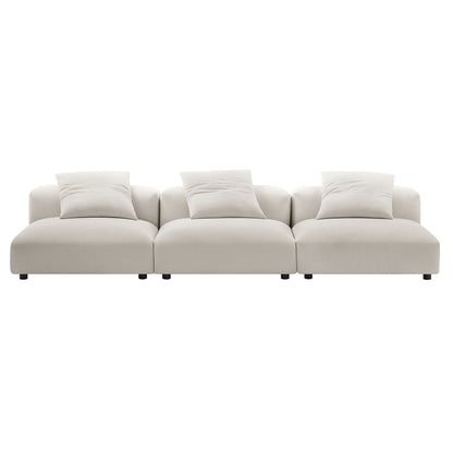 Gray fabric modular sectional sofa with three connected seating sections and matching throw pillows on short legs.