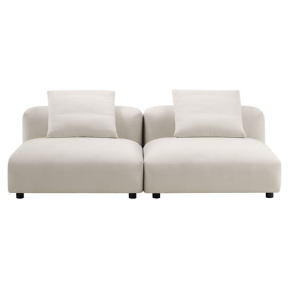 Gray modular sofa with two connected seats, cushioned arms, two throw pillows, low-profile design and short dark legs.
