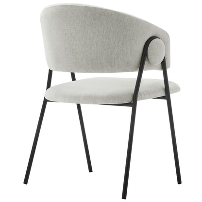 Black fabric upholstered dining chair with curved back, rounded seat, and slim black metal legs.