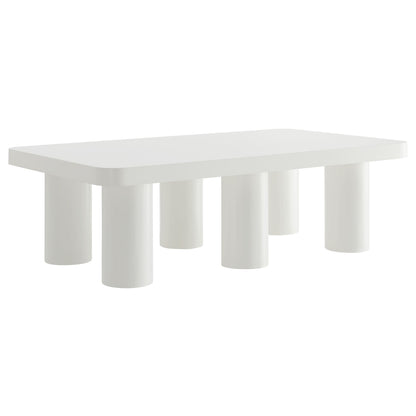 White rectangular coffee table with five chunky cylindrical legs, modern minimalist living room furniture.