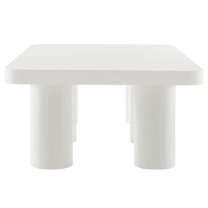 White rectangular coffee table with rounded corners and chunky cylindrical legs.
