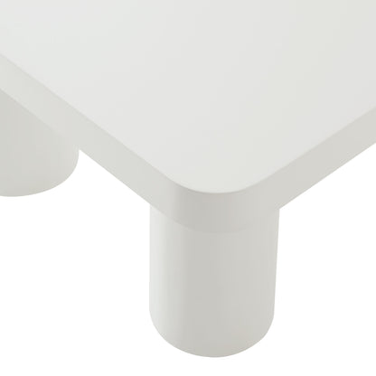 White rectangular coffee table with rounded edges and white cylindrical legs, modern minimalist living room furniture.