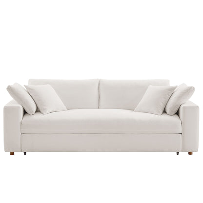 White fabric sleeper sofa with four matching cushions, clean modern lines, low square arms and wooden legs.