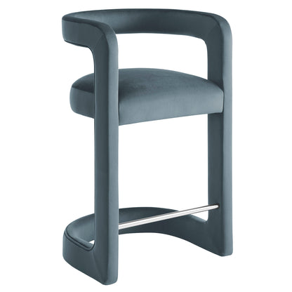 Blue upholstered counter stool with curved continuous frame, padded seat, built-in arms and metal footrest.