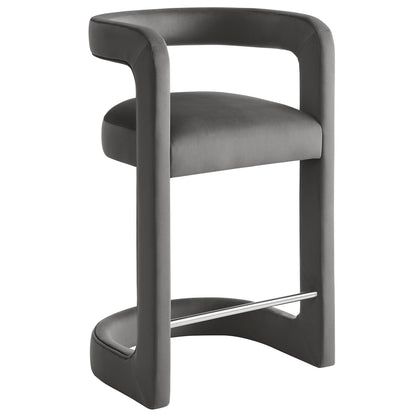 Gray upholstered counter stool with wraparound curved arms, cushioned seat and metal footrest.