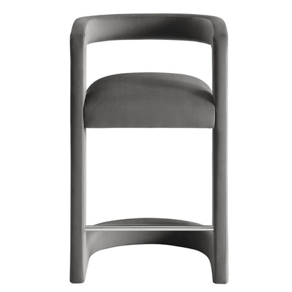 Gray upholstered bar stool with curved backrest and chrome footrest on a modern steel frame.