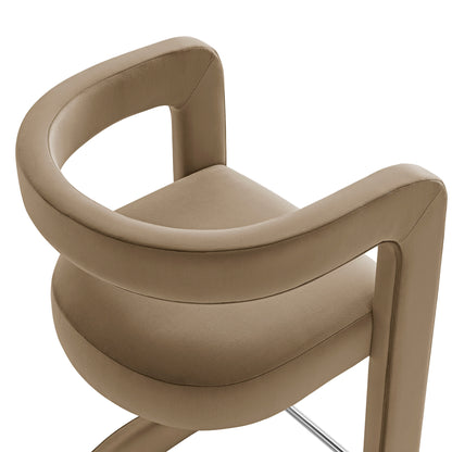 Taupe velvet bar stool with curved back, round cushioned seat and chrome pedestal base.