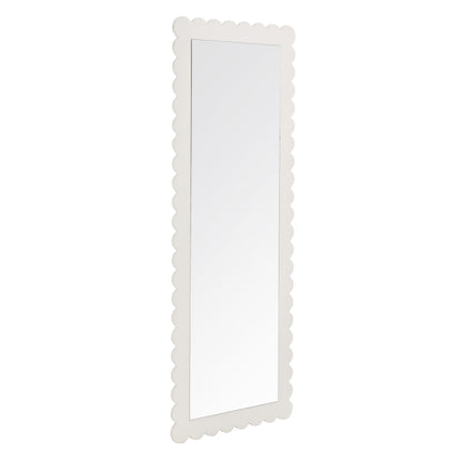 White scalloped-edge full-length floor mirror with slim frame; decorative vintage style.