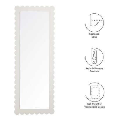 Rectangular floor mirror with a scalloped white frame and reflective glass; freestanding.