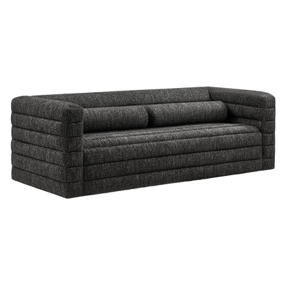 Charcoal textured fabric sofa with chunky channel-stitched arms, three-seat cushions, modern low-profile design.