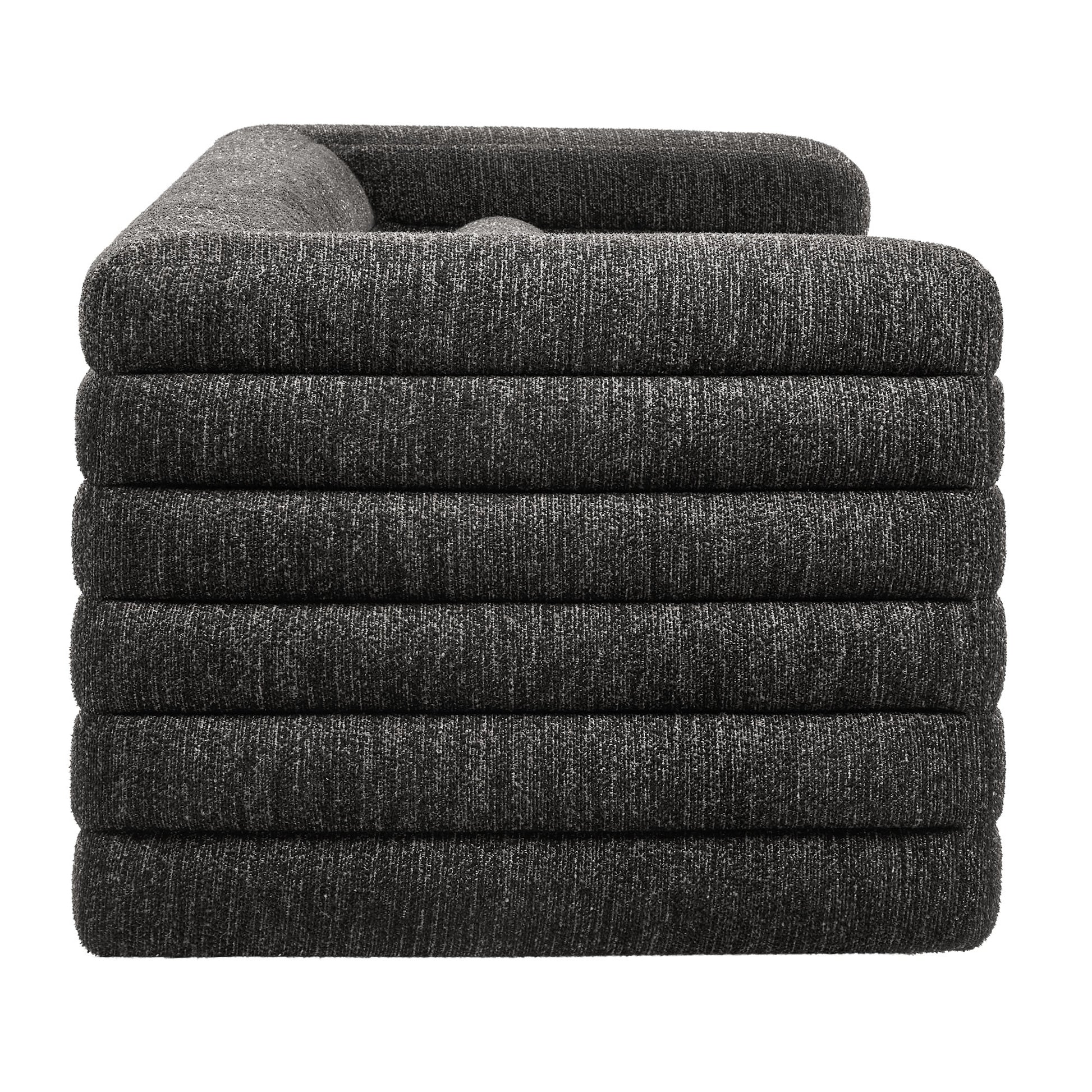 Gray channel-tufted boucle upholstered sofa with padded arms.