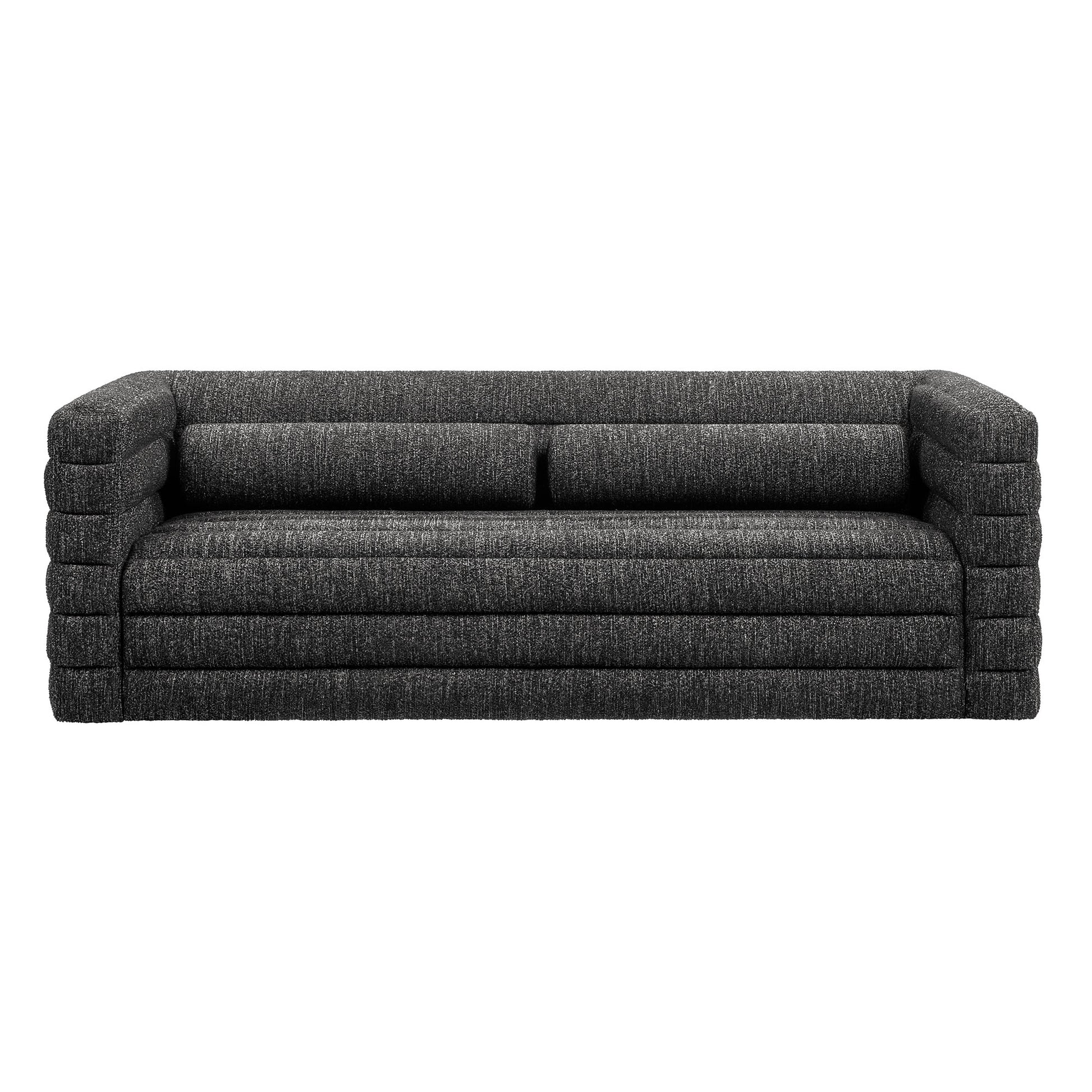 Charcoal gray boucle upholstery sofa with channel tufting and oversized block arms, two-seat cushions, and a low-profile modern lounge.