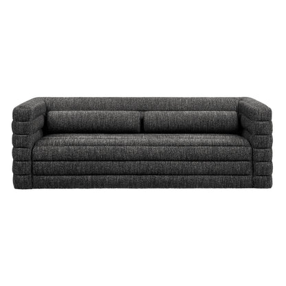 Charcoal gray boucle upholstery sofa with channel tufting and oversized block arms, two-seat cushions, and a low-profile modern lounge.