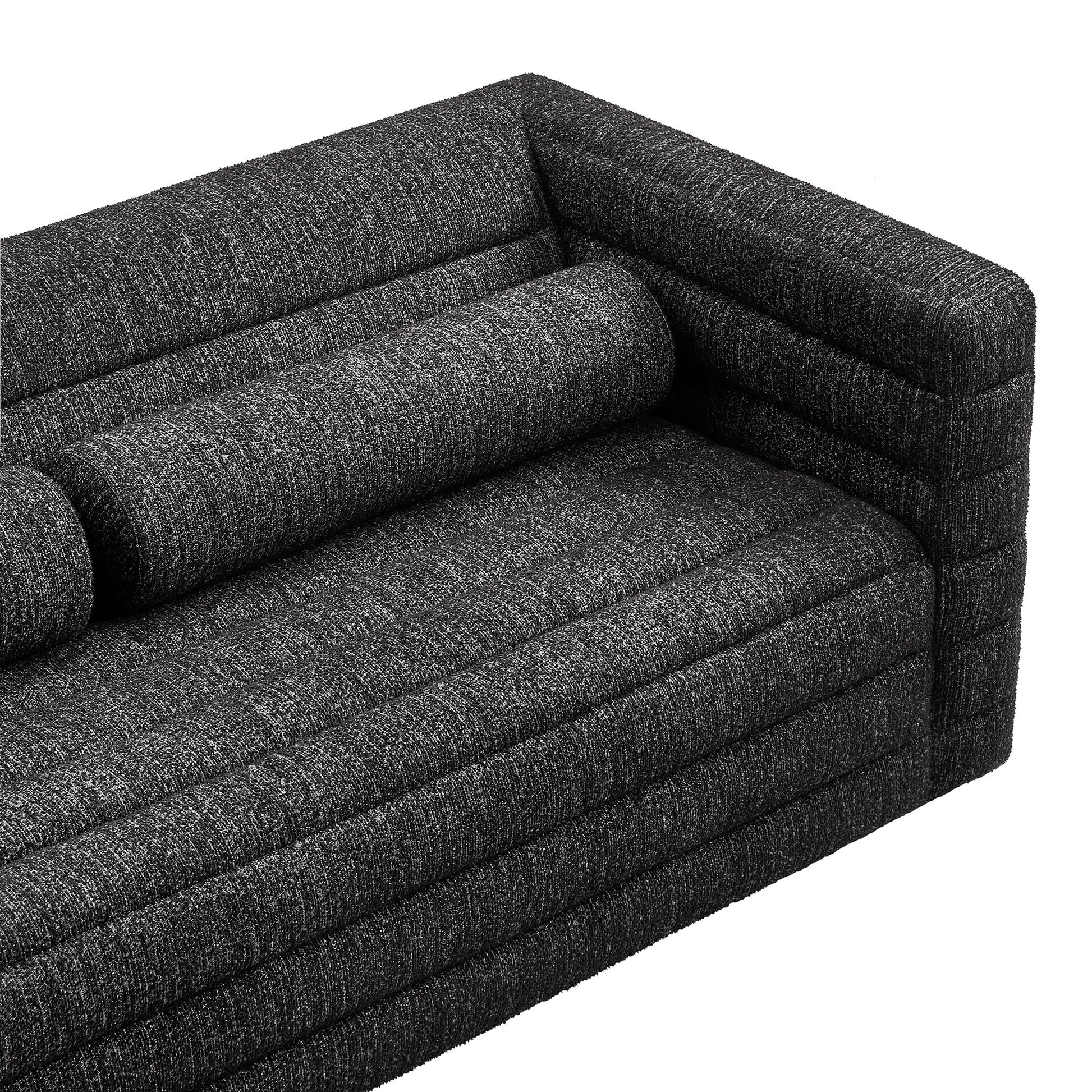 Charcoal gray textured fabric sofa with cylindrical bolster pillows and clean, boxy arms.