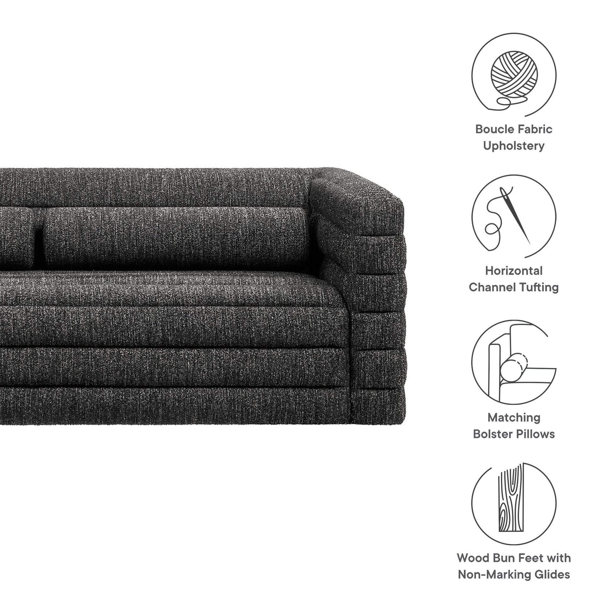 Charcoal boucle fabric upholstery sofa with horizontal channel tufting, matching bolster pillows, wood bun feet with non-marking glides.