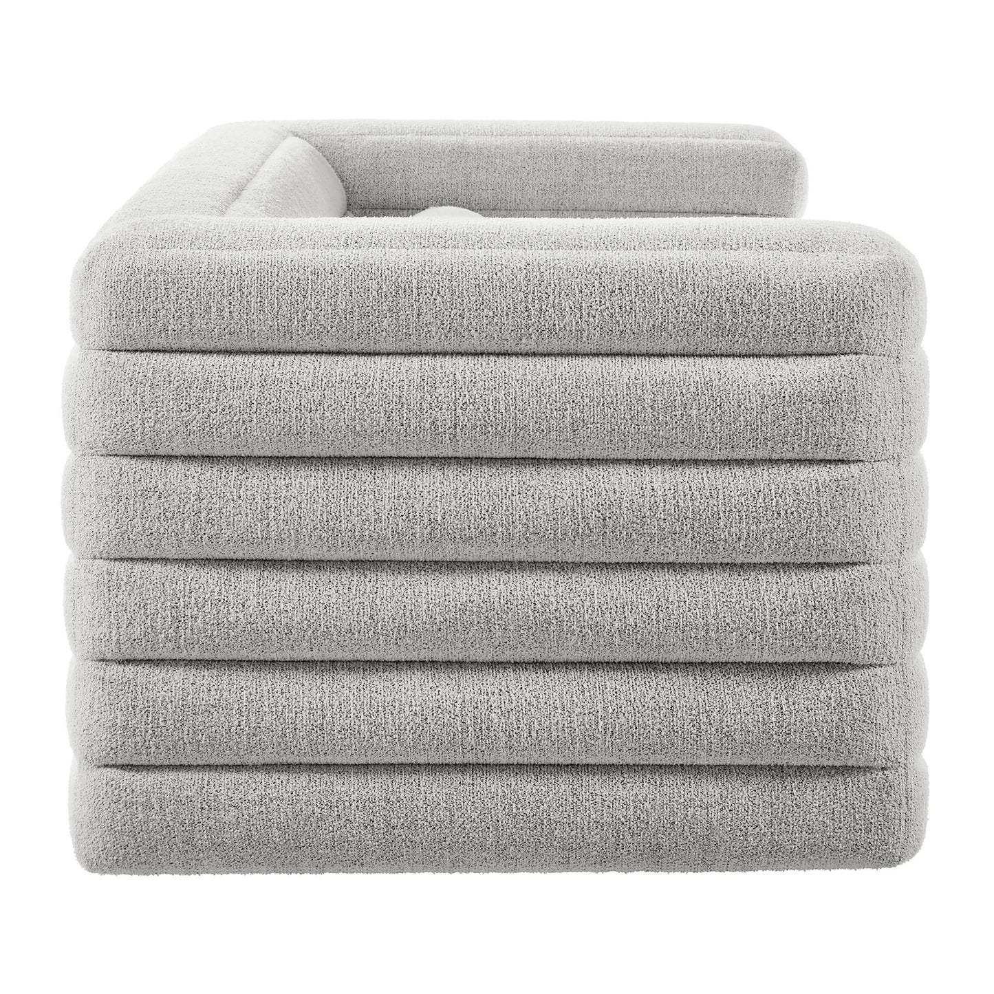 Light gray plush boucle upholstered sofa with channel tufting; modern living room seating.