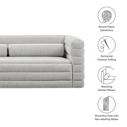 Light gray boucle fabric sofa with channel tufting, matching bolster pillows, wood bun feet with nonmarking glides.