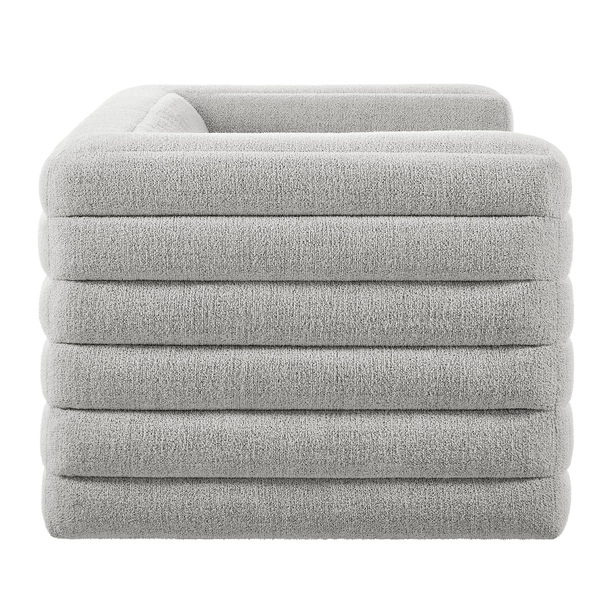 Gray boucle channel-tufted loveseat with plush upholstered seating.