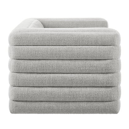 Gray boucle channel-tufted loveseat with plush upholstered seating.