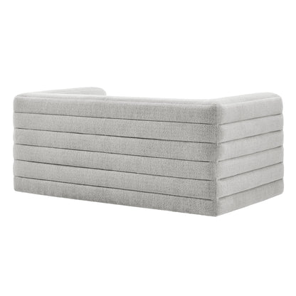 Light gray boucle upholstered loveseat with channel tufting; modern, low-profile living room seating.