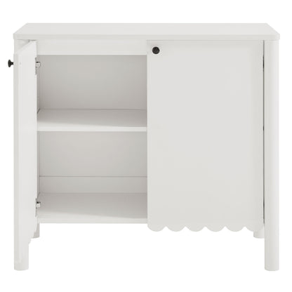 White wooden cabinet with two shelves; left door open, right door closed with scalloped bottom edge and knob.