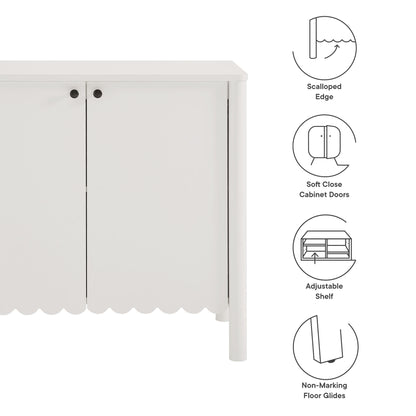 White cabinet with scalloped edge, two doors with round knobs, soft-close doors, adjustable shelf, non-marking floor glides.
