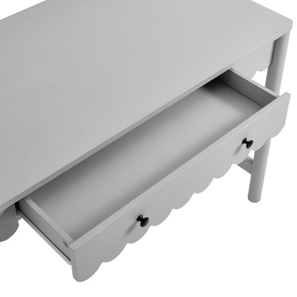 Light gray wooden desk with scalloped drawer front, black knobs, and open center drawer.