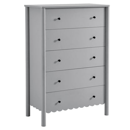 Light gray wooden five-drawer dresser with black knobs, scalloped bottom apron, and slim straight legs.