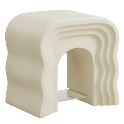 Ivory resin-like sculptural side table with stacked wavy arches and a hollow center, contemporary design.