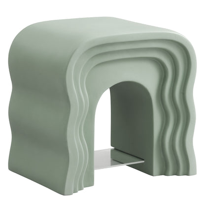 Sage green sculptural squiggle side table with stacked wavy arches and hollow center.