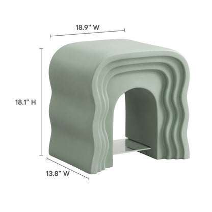 Sage-green sculptural arch side table with nested rounded ridges and metal footrest.