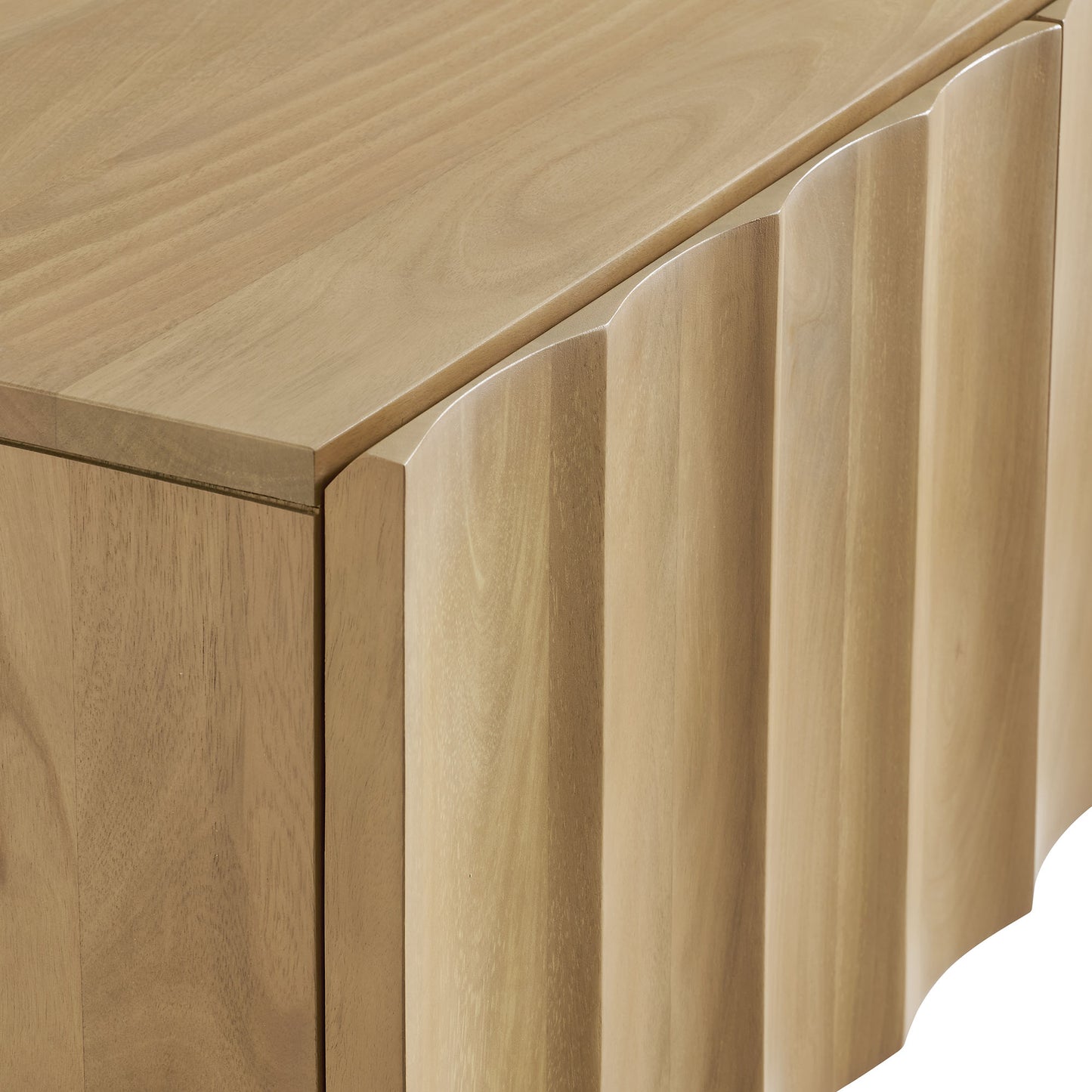 Natural wood TV stand with scalloped vertical panels and a smooth top surface.
