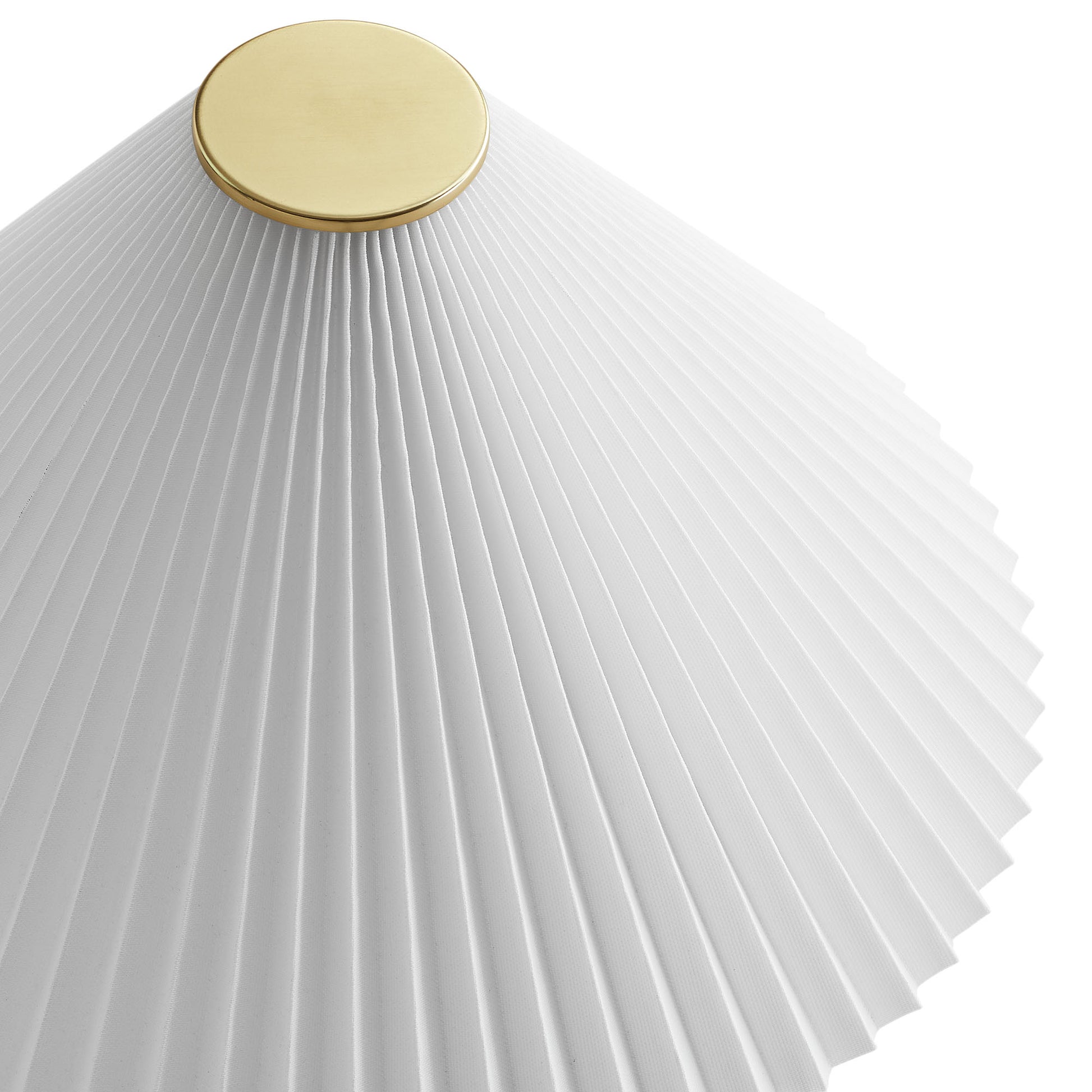 White pleated lampshade with a gold circular finial on a travertine table lamp.