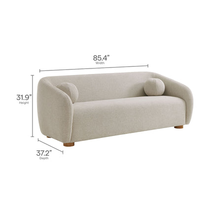 Gray chenille fabric sofa with rounded arms, two circular bolster pillows, and low wooden feet; modern curved design.
