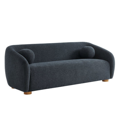 Navy blue curved sofa in fabric with rounded arms, two round cushions, and short wooden legs.