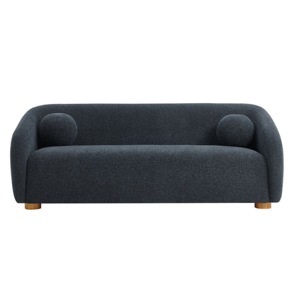 Navy blue curved fabric sofa with rounded arms, two circular accent cushions, and short wooden legs.