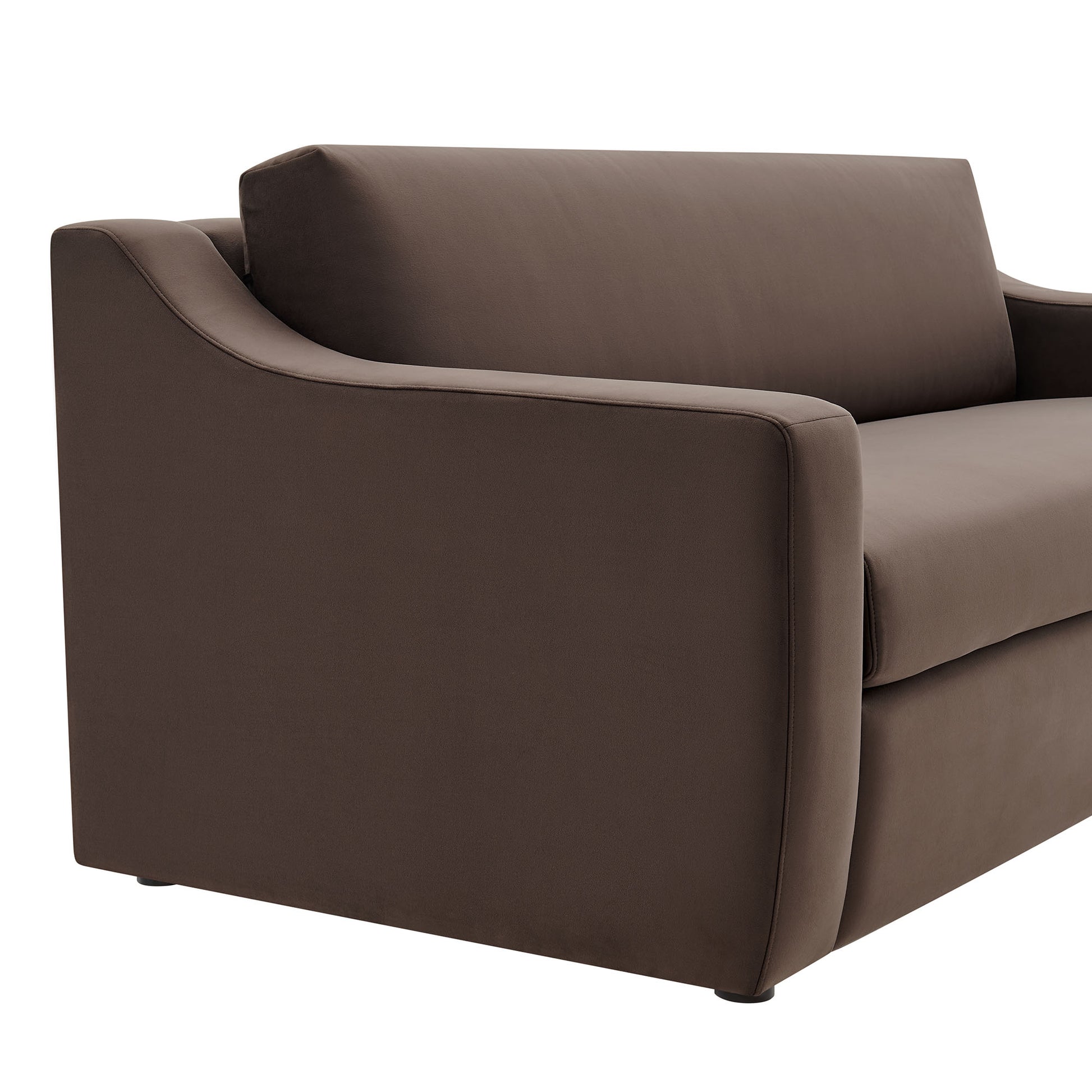 Brown velvet sofa with rounded arms and tailored cushions; contemporary living room seating.