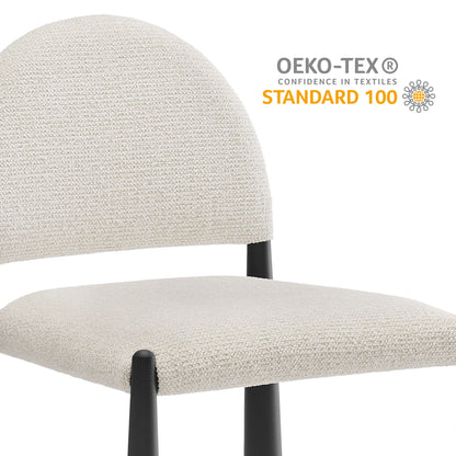 Cream textured fabric dining chair with rounded back and black metal legs; OEKO-TEX Standard 100.