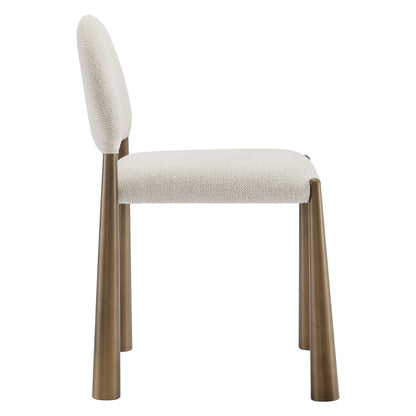 Cream fabric upholstered dining chair with brass-finished wooden tapered legs and a curved backrest.