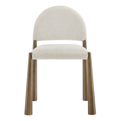 Cream textured upholstered dining side chair with rounded back and warm brass-brown cylindrical legs.