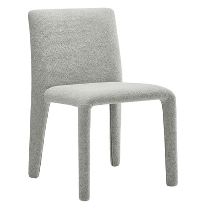 Light gray upholstered dining chair with rounded back and slim legs, modern minimalist style.