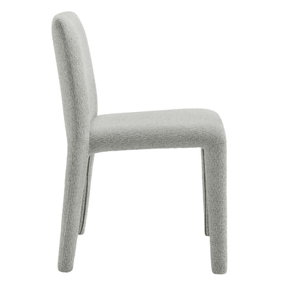 Dove gray boucle upholstered dining chair with tall curved back and rounded legs, side view.