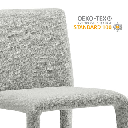 Light gray boucle upholstered chair with rounded back and seamless curved frame.