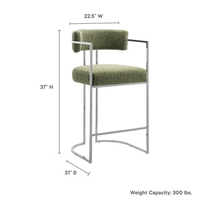 Olive green upholstered counter stool with slim silver metal frame and curved back; rounded base; 37 in height.