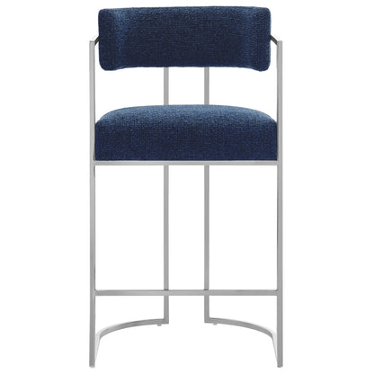 Navy blue fabric upholstered back and seat on a slim silver metal curved-back counter stool.