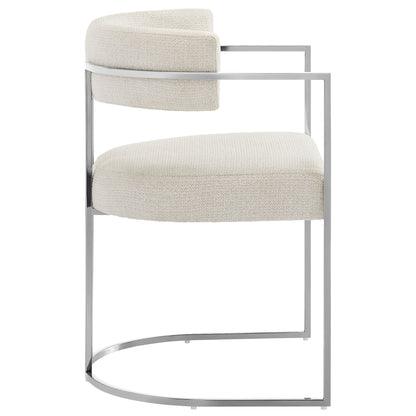 Cream fabric upholstered curved-back dining chair with a silver metal frame and cushioned seat.