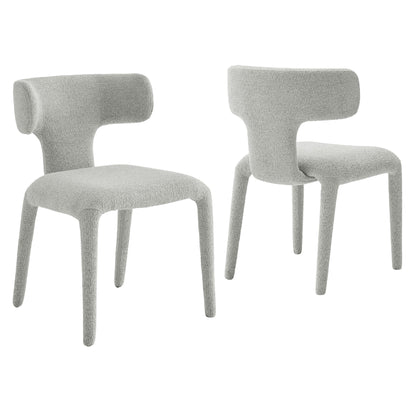 Pair of light gray boucle upholstered dining chairs with curved backs and tapered legs.