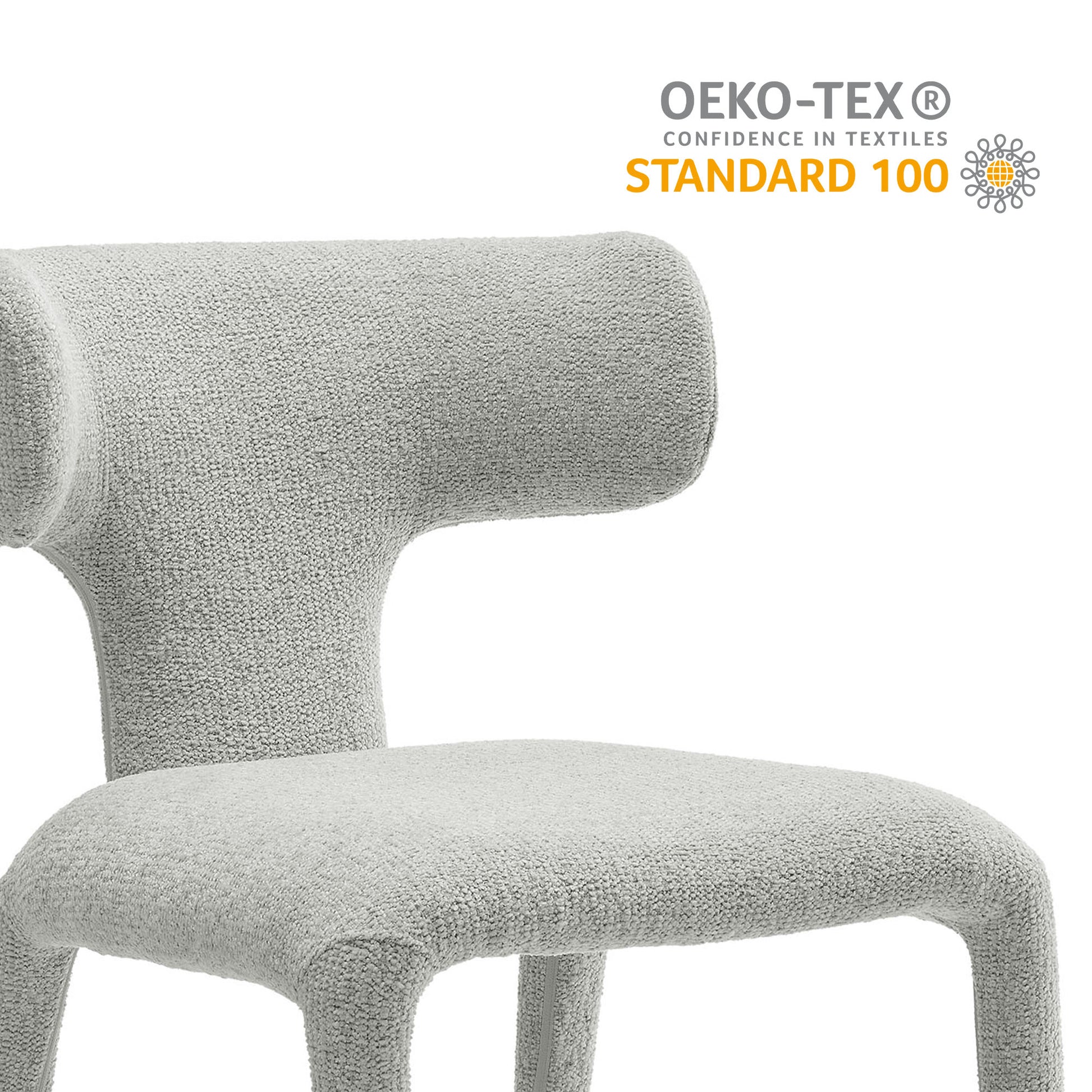 Gray boucle upholstered dining chair with curved back and sculptural, modern design.