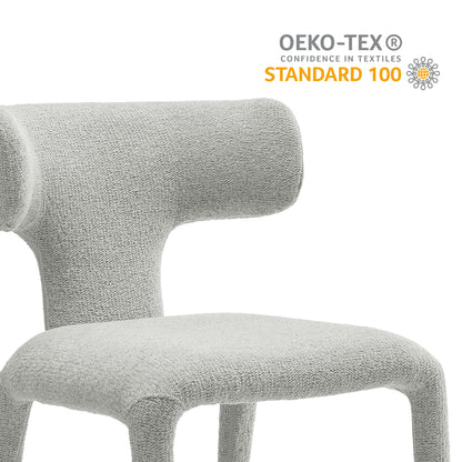 Gray boucle upholstered dining chair with curved back and sculptural, modern design.